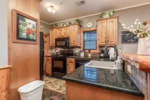 a kitchen with a sink and a counter top at 1BR Village At Indian Point 501 near SDC-Free Tickets Daily up to $500 in Branson +12 photos