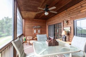 a screened in porch with a table and chairs at 1BR Village At Indian Point 501 near SDC-Free Tickets Daily up to $500 in Branson