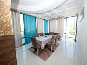 a dining room with a table and chairs at Apartmens Aida Luks in Ulcinj