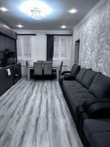 a living room with a couch and a table at Jermuk Cozy Apartment in Jermuk +1 photo