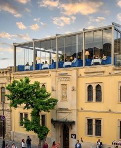 a building with people sitting on a balcony at The Moonlight Luxury Hotel in Baku