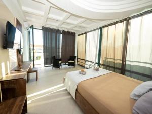a hotel room with a bed and a television at Apartmens Aida Luks in Ulcinj