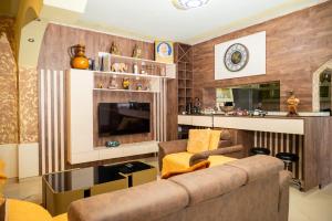 a living room with a couch and a tv at Apartmens Aida Luks in Ulcinj