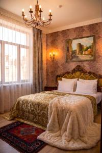 a bedroom with a bed and a chandelier at The Moonlight Luxury Hotel in Baku