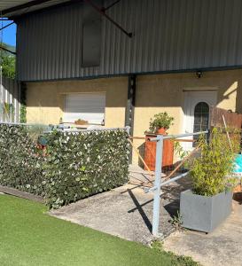 a house with a fence and plants in front of it at LOFT de 60 M2 in Saint-Jean-en-Royans