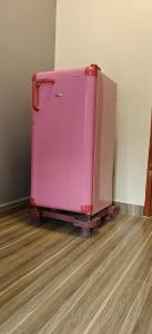 two pink suitcases are sitting in a room at Parisian Evenings Homestay - Madurai in Madurai