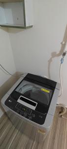 a toaster oven sitting on the floor next to a wall at Parisian Evenings Homestay - Madurai in Madurai +13 photos