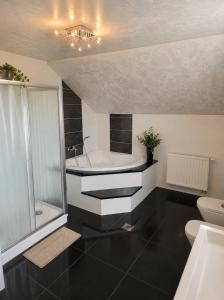 a bathroom with a tub and a sink and a toilet at Grabovica Sobe-Blue Lake Luxury Rooms in Grabovica