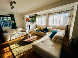 a living room with a white couch and a table at Hadrian House in East Preston