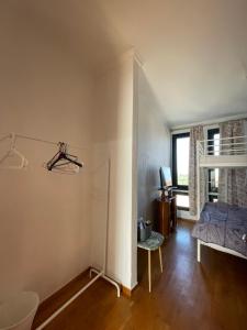 a bedroom with a bed and a desk and a window at Blue House 2 in Paliouri
