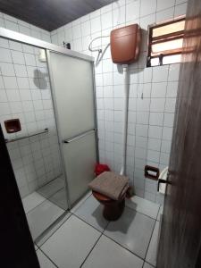 a bathroom with a shower and a toilet in it at Casa da JEANI CLEIDI in Rosário do Sul