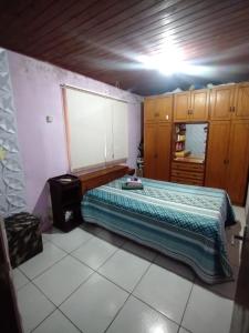 a bedroom with a large bed in a room at Casa da JEANI CLEIDI in Rosário do Sul