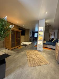 a living room with a couch and a refrigerator at Les Nuits Douces in Bitche