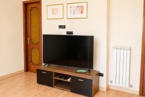 a flat screen tv sitting on a stand in a living room at Tari Home Crotone in Crotone