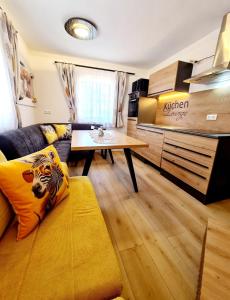 a living room with a couch and a table at Apartment Katzensilber in Rothenthurm
