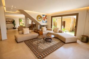 a living room with two couches and a rug at Villa a cabonegro tetouan in Tétouan