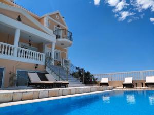 a villa with a swimming pool and patio furniture at Irini's Villa in Argostoli