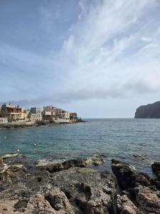 a group of buildings on the shore of a body of water at Mani Spot by the Sea in Gerolimenas