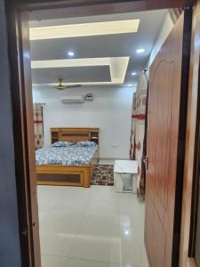 a small bedroom with a bed and a ceiling at Private Duplex Stay with Open Terrace in Meerut