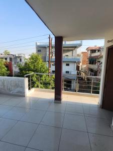 a balcony with a view of a city at Private Duplex Stay with Open Terrace in Meerut +9 photos
