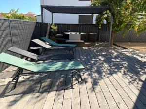 a patio with two lounge chairs and a table at Maison 5mn de la mer in Fréjus