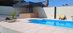 a swimming pool in the backyard of a house at Solar da Pedra in Paços de Ferreira