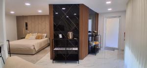 a room with a bedroom with a bed and a book shelf at Solar da Pedra in Paços de Ferreira +26 photos