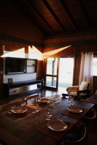 a dining room table with wine glasses on it at Oliveira mountain House in Tijucas