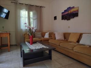 a living room with a couch and a coffee table at Vanilla House Paleokastritsa in Paleokastritsa
