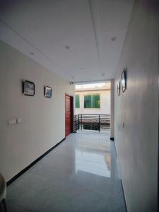a hallway of a building with white walls and a door at Snow Stones in Khaira Gali