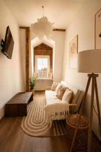 a living room with a couch and a table at Jainty Apartments Bytom in Bytom