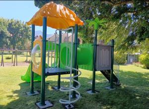 a playground with a slide in a park at Departamento en el Centro de Pucón, Hermosa vista al lago !! in Pucón