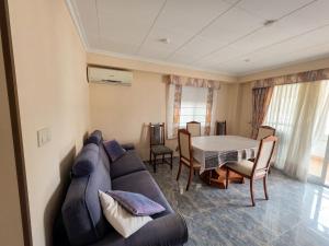 a living room with a couch and a table at Ático vistas al mar in Cullera