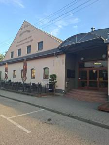 a building with a restaurant on the side of a street at Penzion Borlitz in Pohořelice