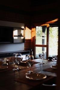 a dining room table with wine glasses on it at Oliveira mountain House in Tijucas