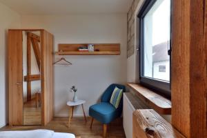 a room with a blue chair and a window at Ferienwohnung Am Eselsburger Tal in Herbrechtingen