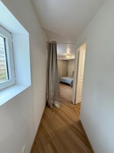 an empty room with a window and a bedroom at Le Grimpeur in Achères-la-Forêt