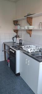 a kitchen with a black and white stove top oven at Bluebird apartman in Zalakaros