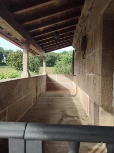 an empty walkway in a building with a window at Casa da Torreira Naturaleza y descanso in Galegos +80 photos