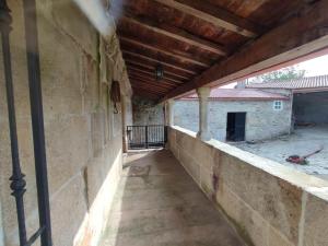 an empty balcony of a building with a wooden ceiling at Casa da Torreira Naturaleza y descanso in Galegos