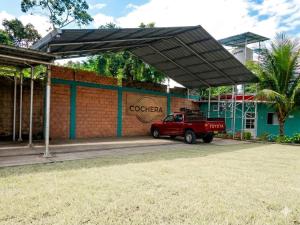 a red truck parked in front of a building at Casa Hospedaje en Tarapoto in Tarapoto