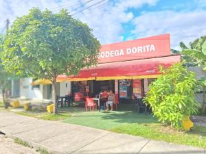 a restaurant with a red awning and tables and chairs at Casa Hospedaje en Tarapoto in Tarapoto