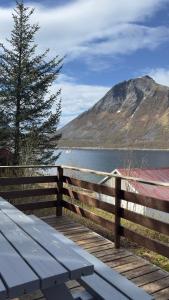 a bench sitting on a wooden boardwalk next to a lake at Salt&Stone in Gryllefjord +6 photos