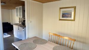 a kitchen with a table and a kitchen with a table and a table at Salt&Stone in Gryllefjord