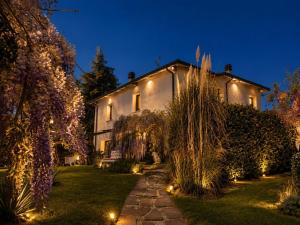 a house with lights in the yard at night at Gan Eden B&B in Monterenzio