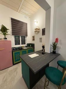 a kitchen with a counter and two stools in a room at Melita Living in Sliema