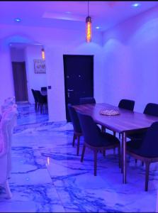 a dining room with a purple table and chairs at Apartments 4B Block B in Lagos