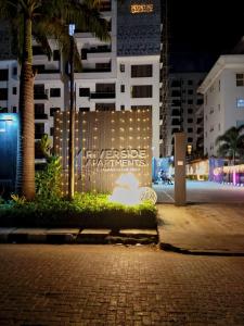 a lit up sign in front of a building at night at Apartments 4B Block B in Lagos