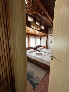 a room with two beds in a room with a door at Rooms Merlika -Inside the Castle- in Krujë