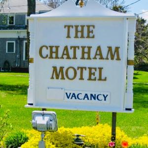 a sign for the chatham motel in a yard at The Chatham Motel in Chatham +85 photos